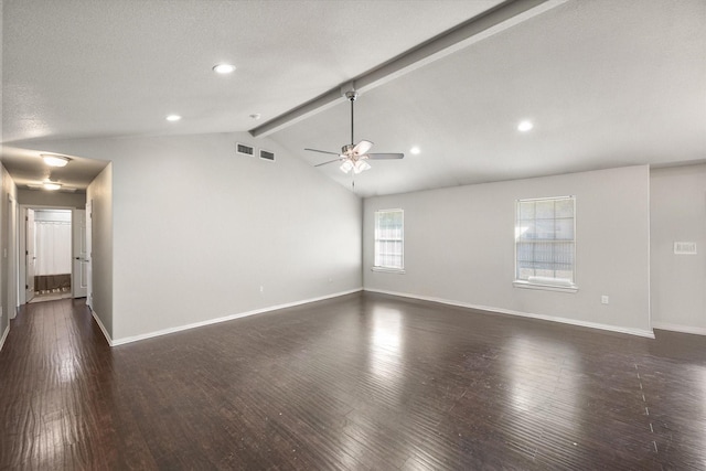 unfurnished room with lofted ceiling with beams, a textured ceiling, wood finished floors, a ceiling fan, and baseboards