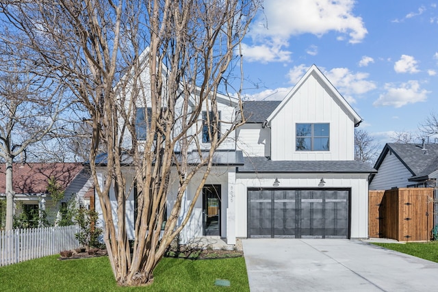 modern inspired farmhouse featuring roof with shingles, concrete driveway, an attached garage, board and batten siding, and fence