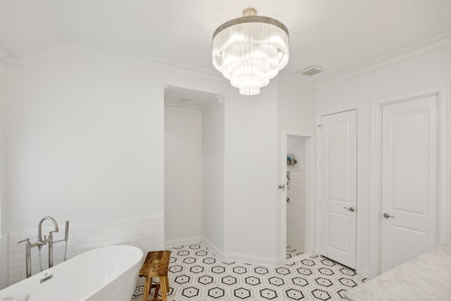 bathroom featuring a soaking tub, crown molding, tile patterned flooring, and a notable chandelier