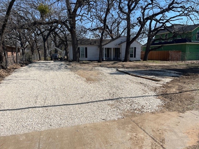 view of front of house with driveway and fence