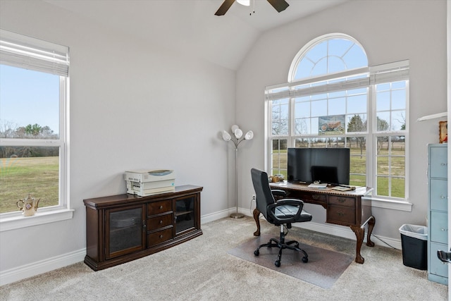 carpeted office space featuring lofted ceiling, a ceiling fan, and baseboards