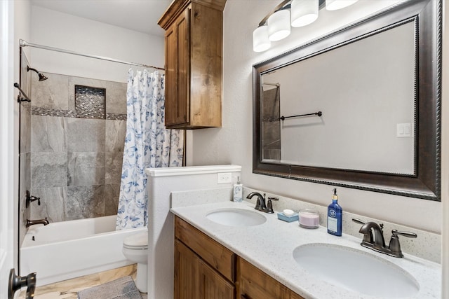 full bathroom featuring toilet, double vanity, shower / bath combo, and a sink