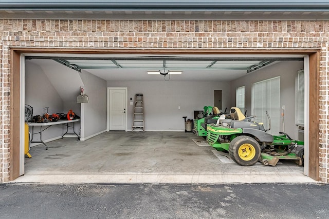 garage featuring driveway and electric panel