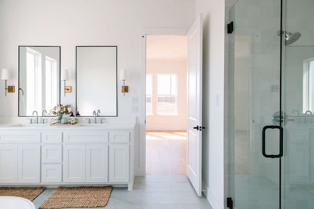 bathroom with a sink and a shower stall