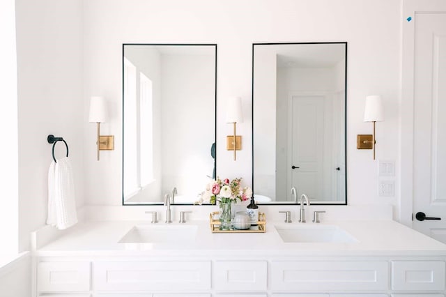 full bath featuring double vanity and a sink