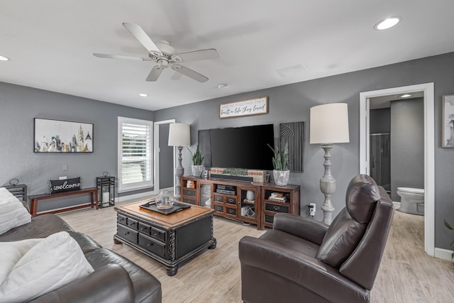 living room with light wood-type flooring, baseboards, a ceiling fan, and recessed lighting