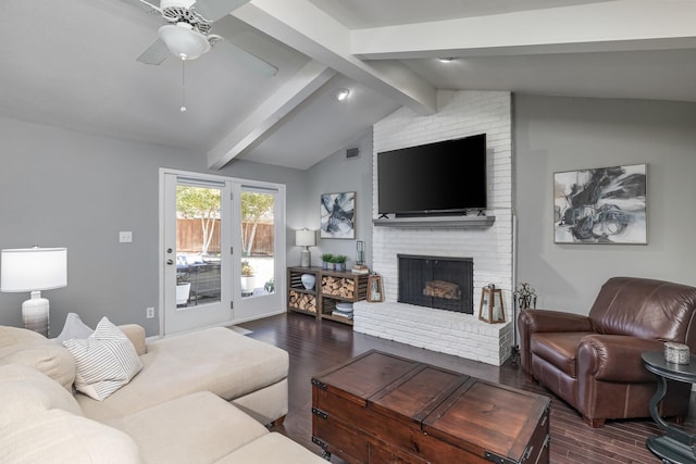 living area with dark wood-style flooring, vaulted ceiling with beams, visible vents, a ceiling fan, and a brick fireplace