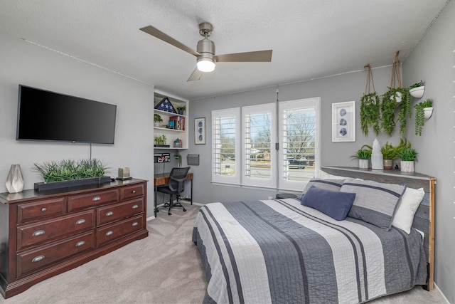 bedroom featuring access to exterior, light carpet, ceiling fan, and a textured ceiling