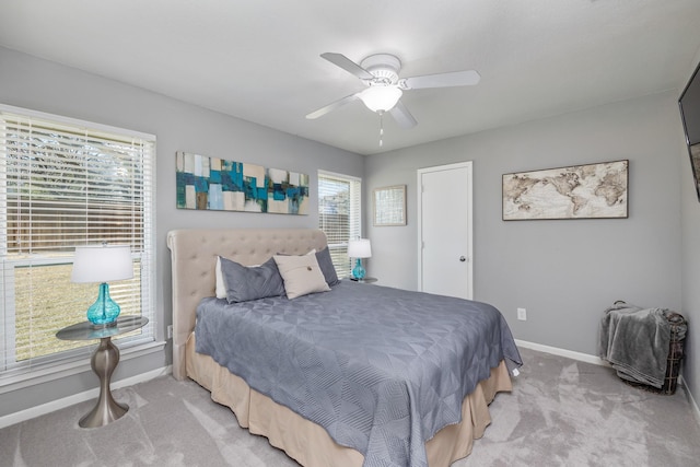 bedroom featuring baseboards, a ceiling fan, and light colored carpet