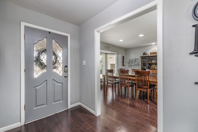 entrance foyer featuring dark wood-type flooring, recessed lighting, and baseboards