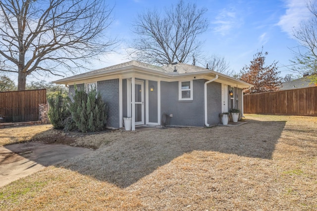 view of front of property featuring brick siding and fence