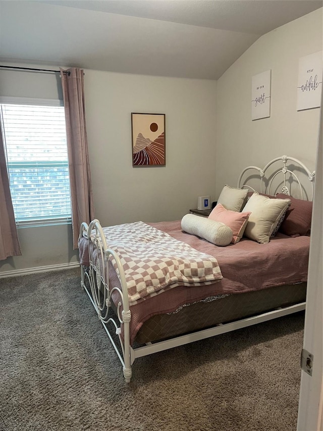 bedroom with carpet floors and vaulted ceiling