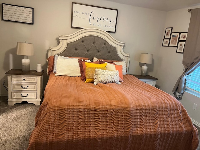 bedroom featuring baseboards and carpet flooring