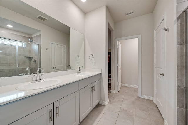 6116 Pathfinder Trl, Fort Worth, TX 76179 - full bathroom with double vanity, a stall shower, a walk in closet, tile patterned flooring, and baseboards