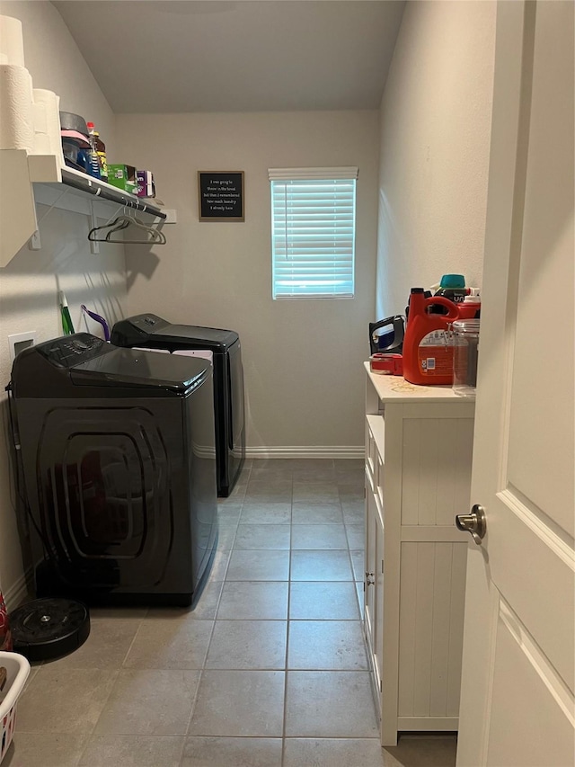 laundry room with laundry area, washer and clothes dryer, baseboards, and light tile patterned floors