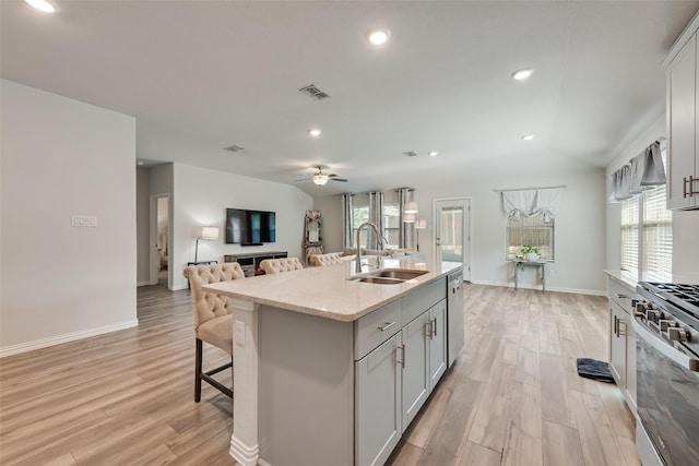 6116 Pathfinder Trl, Fort Worth, TX 76179 - kitchen with a sink, appliances with stainless steel finishes, light wood-style flooring, open floor plan, and a ceiling fan