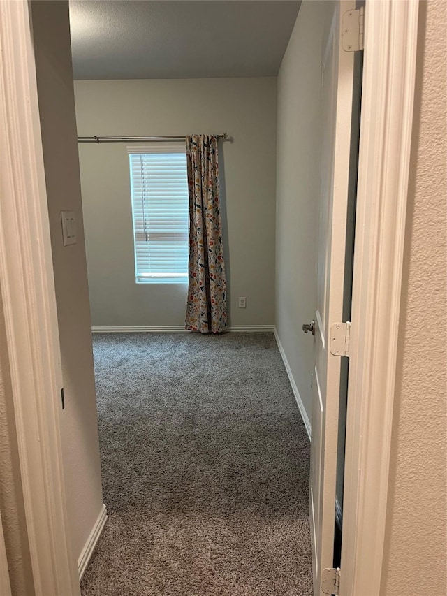 empty room with carpet floors and baseboards