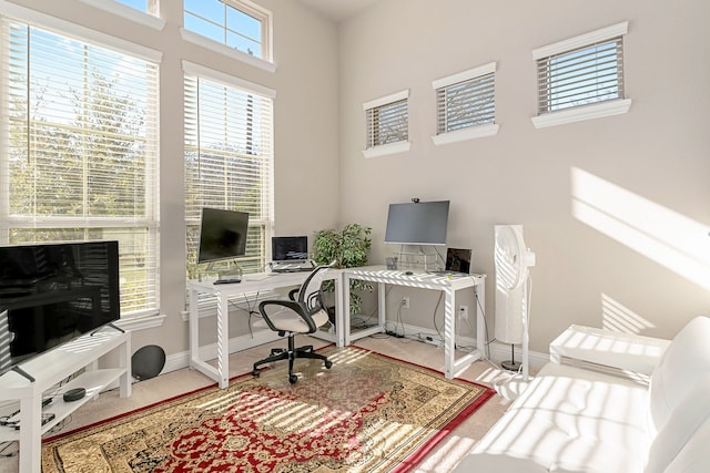 carpeted office space with baseboards