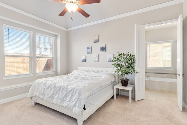 carpeted bedroom featuring a ceiling fan, connected bathroom, baseboards, and crown molding