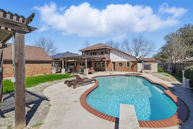 view of swimming pool featuring a patio area, a fenced backyard, and a diving board