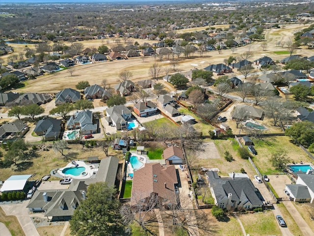 aerial view of property's location with a pool and nearby suburban area