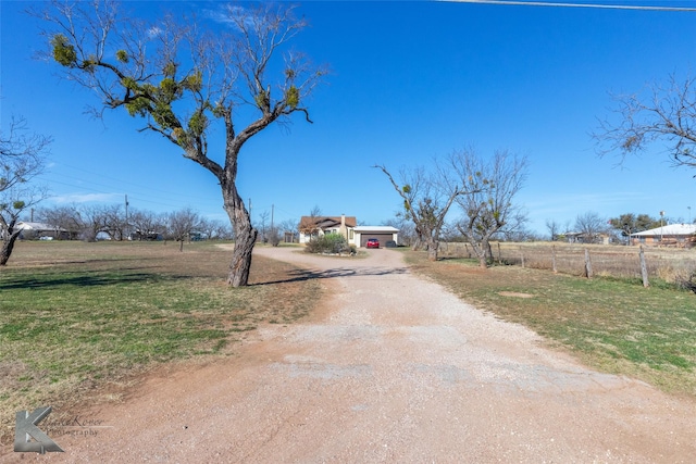 view of road with dirt driveway