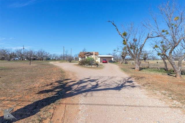 view of road featuring dirt driveway