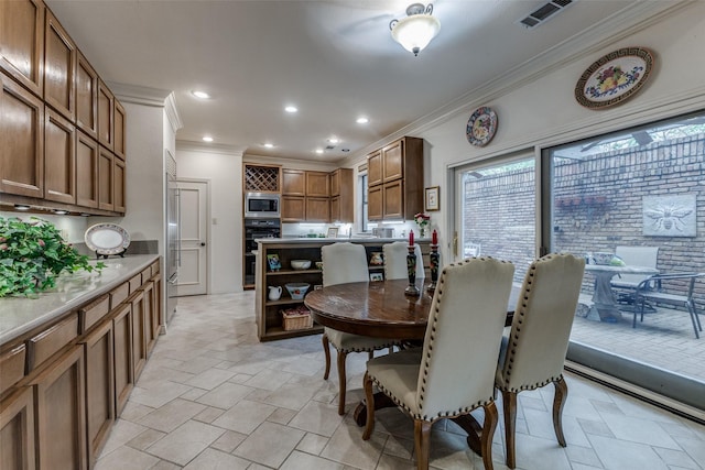 dining room featuring stone finish floor, visible vents, crown molding, and recessed lighting