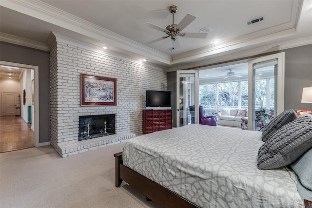 carpeted bedroom with ornamental molding, visible vents, and a fireplace