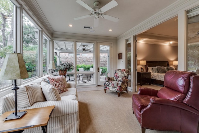 sunroom with plenty of natural light, visible vents, and a ceiling fan