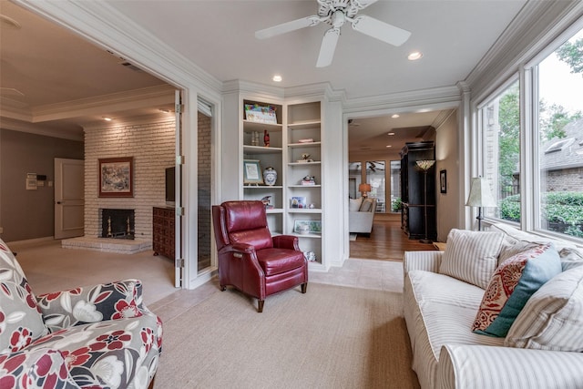 living area featuring ceiling fan, light colored carpet, recessed lighting, ornamental molding, and a brick fireplace