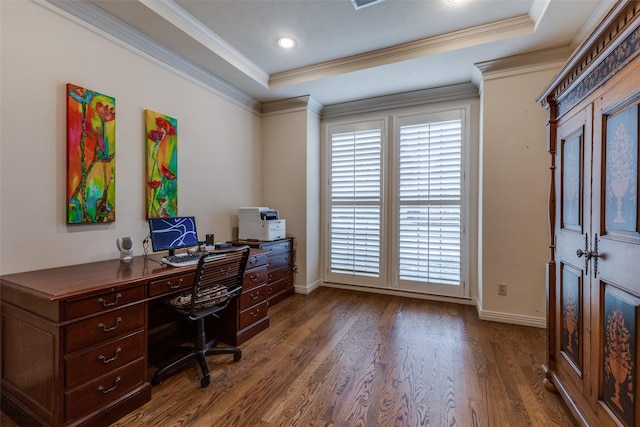 office with dark wood-style floors, ornamental molding, a raised ceiling, and baseboards