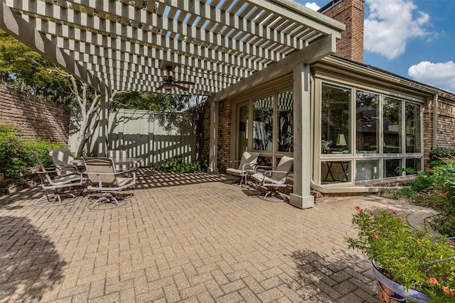 view of patio / terrace featuring a ceiling fan, fence, and a pergola