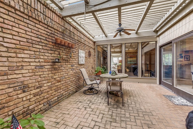 unfurnished sunroom featuring a ceiling fan