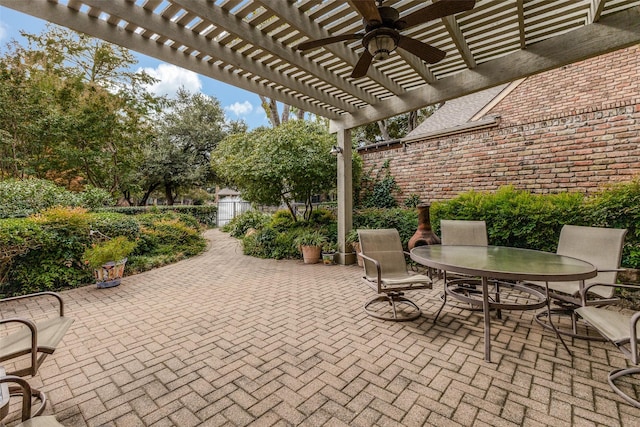 view of patio / terrace featuring a ceiling fan, fence, a pergola, and outdoor dining space