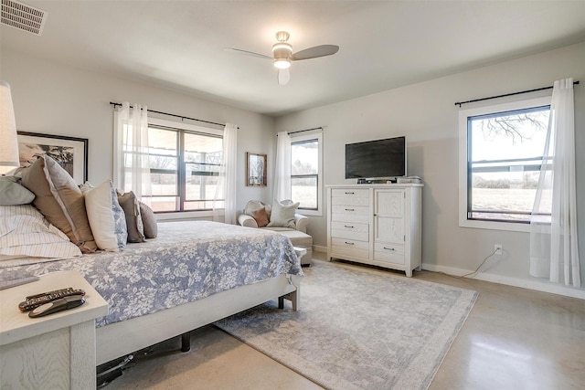 bedroom featuring baseboards, visible vents, concrete flooring, and a ceiling fan