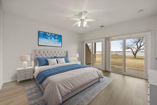 bedroom with access to exterior, visible vents, light wood-style floors, ceiling fan, and baseboards