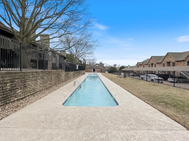 pool featuring a patio area, a residential view, and fence