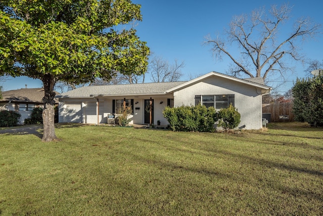 ranch-style home featuring driveway, an attached garage, fence, a front lawn, and brick siding