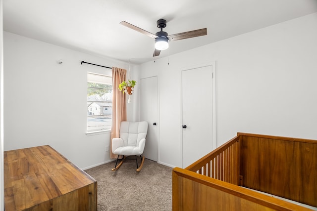 bedroom with a crib, ceiling fan, and carpet flooring