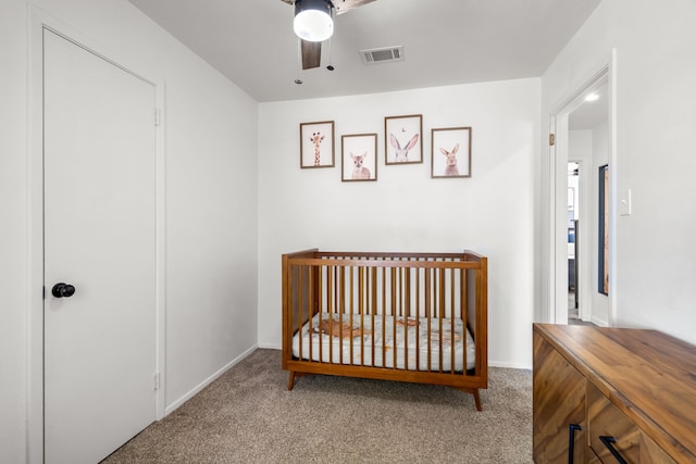 carpeted bedroom with visible vents, ceiling fan, and baseboards