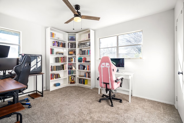 carpeted home office featuring ceiling fan and baseboards