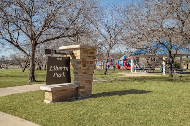 view of home's community featuring playground community and a lawn