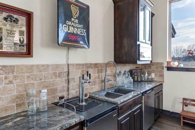 kitchen featuring a sink, dark brown cabinetry, and dishwasher