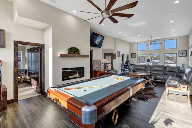 game room with pool table, recessed lighting, wood finished floors, and a glass covered fireplace