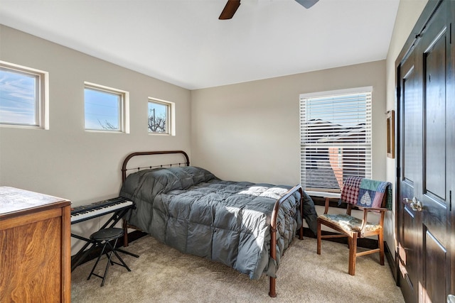 bedroom featuring light carpet and ceiling fan