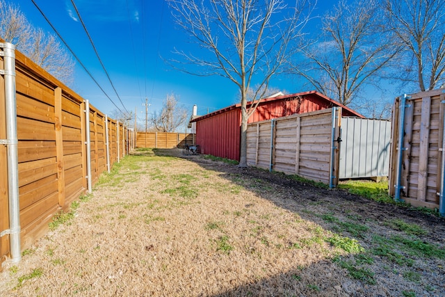 view of yard featuring an outbuilding and a fenced backyard