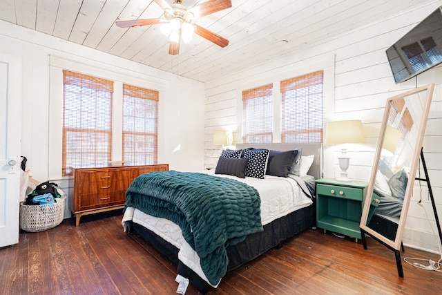 bedroom featuring ceiling fan, multiple windows, dark wood-style flooring, and wooden ceiling