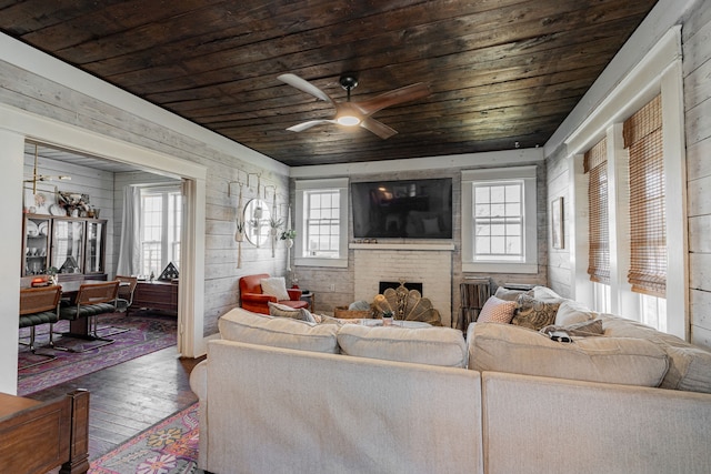 living room with a wealth of natural light, hardwood / wood-style flooring, a fireplace, and wood ceiling