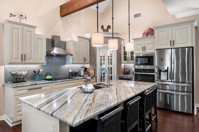 kitchen featuring a sink, visible vents, wall chimney range hood, high vaulted ceiling, and appliances with stainless steel finishes